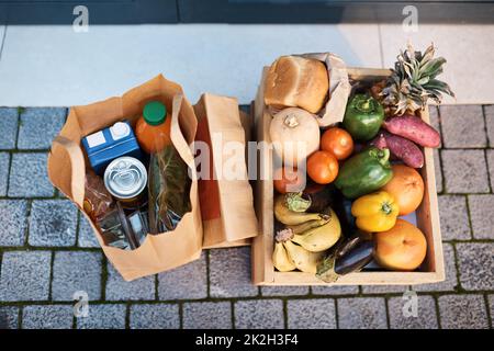 We deliver so you can stay safe at home. Shot of groceries delivered to a customers door. Stock Photo