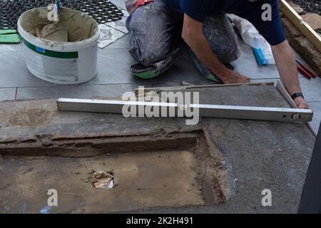 Man laying floor tiles Stock Photo