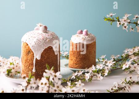 Easter cake with glace icing and decoration. Postcard with Easter bread. Christian traditions. Copy space. White background. Stock Photo