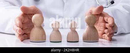 Doctor Protecting Family Stock Photo