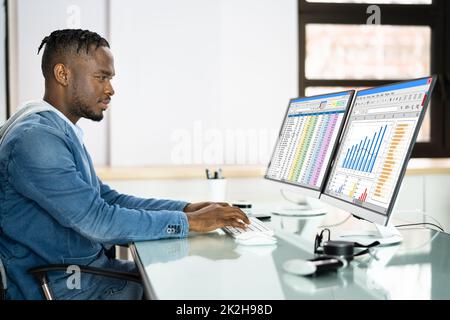 Data Analyst African Man Using Spreadsheet Stock Photo