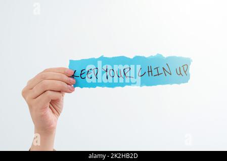 Conceptual caption Keep Your Chin UpRemain cheerful in difficult circumstances High Spirit. Concept meaning Remain cheerful in difficult circumstances Stock Photo