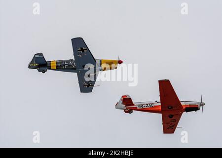 Bucharest, Romania, 4 Sep 2022: Airshow with planes performing acrobatic flight on blue sky, Aeroclubul Romanieie aerobatic team Stock Photo