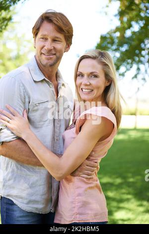 He gives me that feeling. Portrait of an affectionate mature couple enjoying a day in the park. Stock Photo