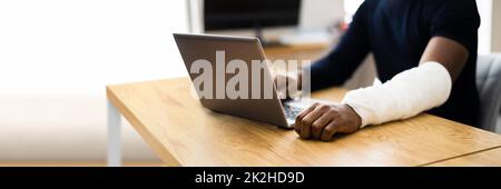 Injured Worker Compensation. Broken Arm African Man Stock Photo