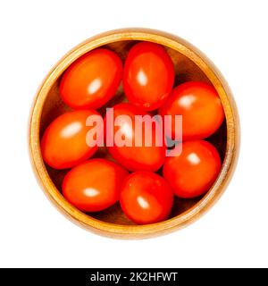 Red grape tomatoes, cocktail tomatoes in a wooden bowl Stock Photo