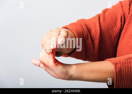 The woman she holding her wrist of hands Stock Photo