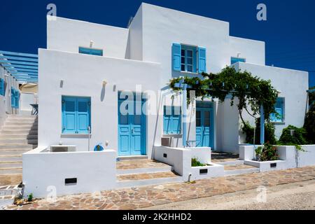 Traditional greek architecture houses painted white with blue doors and window shutters Stock Photo