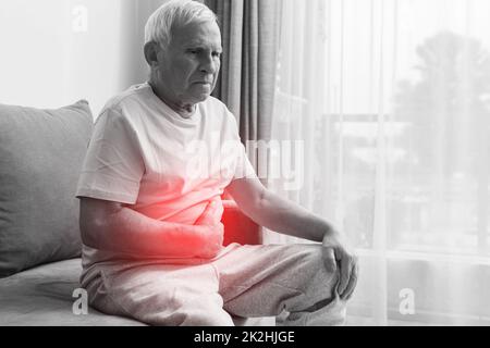 Senior man is suffering from problems with a digestion Stock Photo