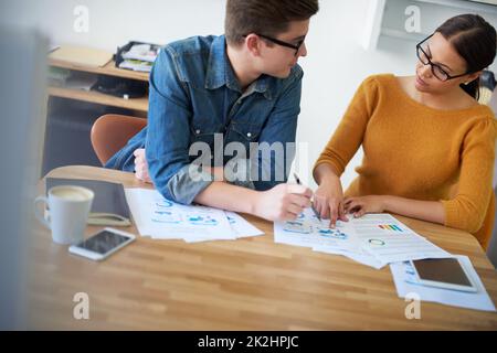 Working away at their latest project. two colleagues working together on a creative project. Stock Photo