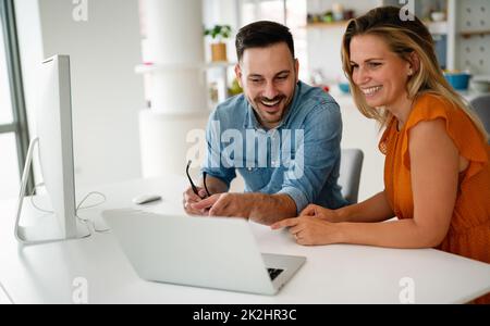 Programmers cooperating at IT company developing apps Stock Photo