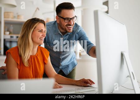 Programmers cooperating at IT company developing apps Stock Photo