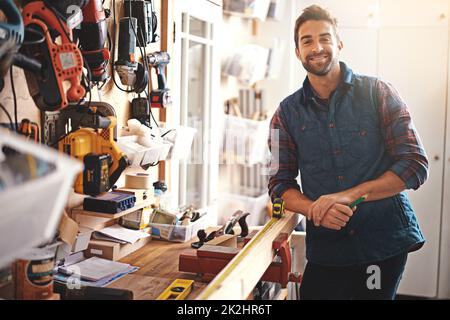 I love working with my hands. Portrait of a man standing in his workshop. Stock Photo