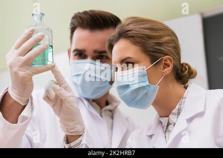 Scientist colleagues is working with a chemical reagents in a laboratory during research Stock Photo