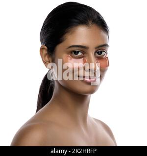 Beautiful Indian woman with hydrating eye patches under her eyes Stock Photo