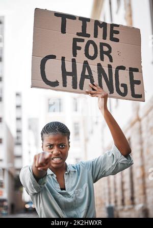 Women are leaders everywhere you look. Shot of a young woman protesting in the city. Stock Photo