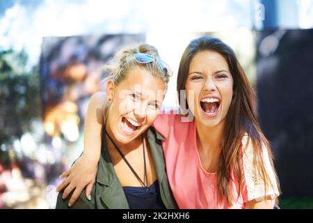 Having fun with my best friend. Two young female friends having fun at an outdoor event. Stock Photo