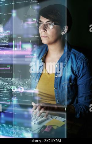 Writing code and developing software. Cropped shot of a young computer programmer looking through data. Stock Photo