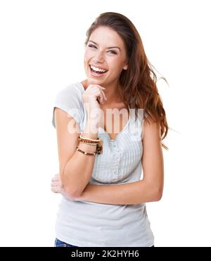 Her laughter is infectious. A pretty young brunette laughing while isolated on a white background. Stock Photo