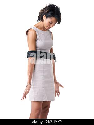 Trapped in her career. Studio shot of a businesswoman tied up with ropes against a white background. Stock Photo