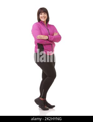 Ready to get fit. Full length shot of a plus size model in exercise clothes isolated on white. Stock Photo