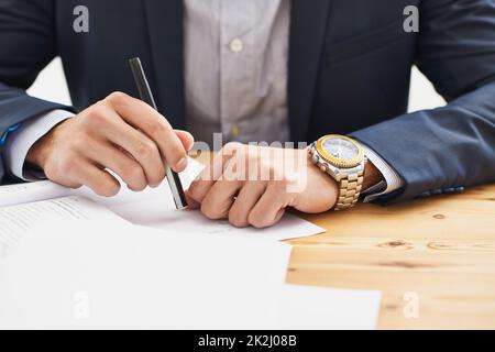 Making lists. Cropped shot of a business man writing. Stock Photo