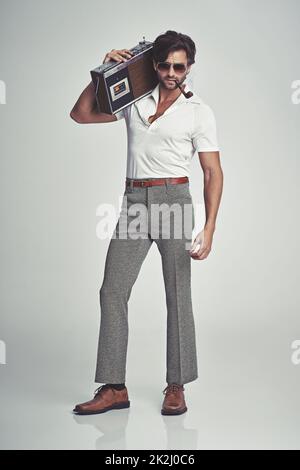 Stepping out with his tunes - 70s style Stock Photo