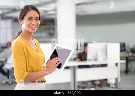 Business gone digital. An attractive businesswoman using a tablet in the office. Stock Photo