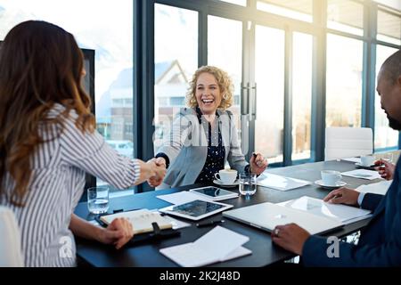 Welcome aboard. Shot of two corporate businesswomen shaking hands during a meeting in the boardroom. Stock Photo