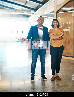 Yes, were the most creative pioneers around. Portrait of two young designers standing together in an office. Stock Photo