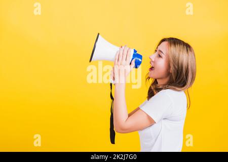 woman teen standing making announcement message shouting screaming in megaphone Stock Photo