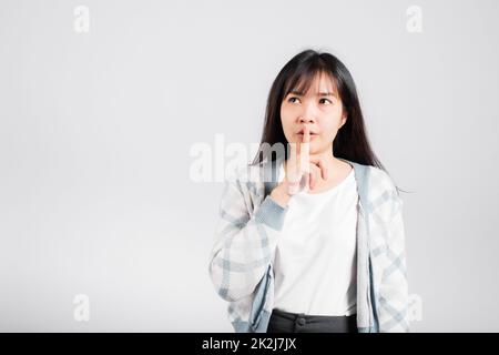 Woman making finger on lips mouth silent quiet gesture Stock Photo
