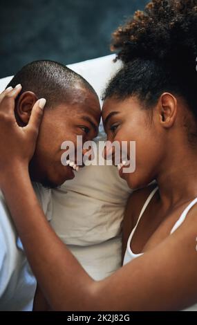Ill love you all of my life. High angle shot of a happy young couple sharing an affectionate moment together in bed. Stock Photo