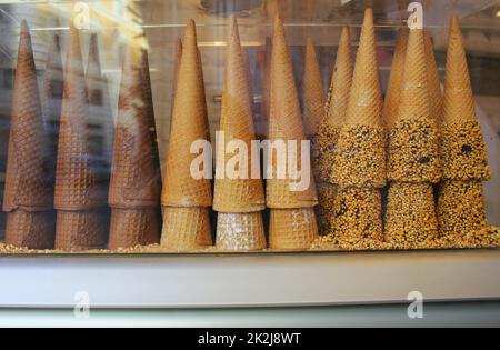 A pile of waffle cones for ice cream ready to be filled with ice cream in a cafe, restaurant. Showcase of a cafe, a pastry shop, a restaurant Stock Photo