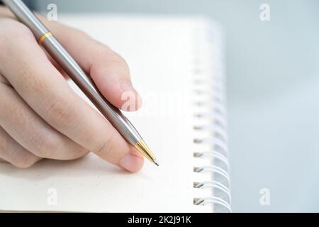 Hands working writing notebook on desk Stock Photo