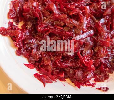 Close-up of boiled grated beetroot on a white plate, the concept of healthy nutrition, organic vegetables Stock Photo