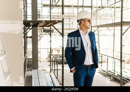 Engineer builder wearing suit and helmet at construction site Stock ...