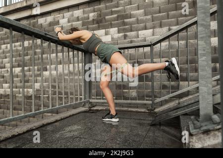 Athletic woman during workout with a resistance rubber band Stock Photo