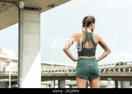 Attractive motivated young healthy fitness woman wearing sports bra and  shorts isolated over black background, running Stock Photo - Alamy