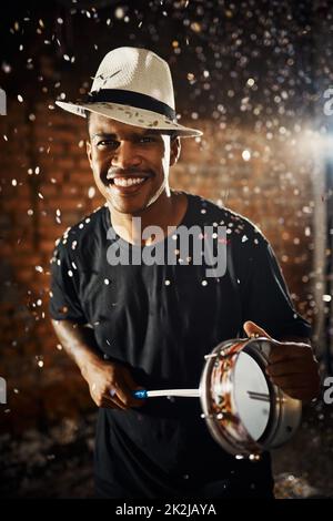 Playing to the groovy beat. Portrait of a young musical performer playing drums. Stock Photo