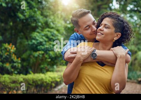 I wanna spend very spring with you. Cropped shot of an affectionate couple embracing each other at the park. Stock Photo