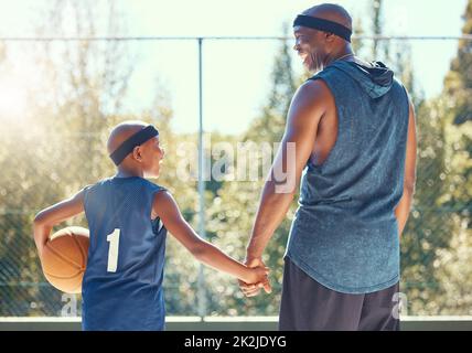 Basketball, family and sport with a dad and son training on a court outside for fitness and fun. Children, exercise and workout with a father and boy Stock Photo