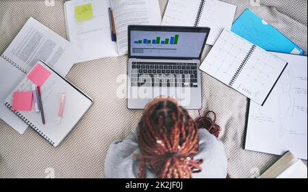 College education and study laptop on bed with school books and sticky notes in home. University student studying graph, analytics and reading digital Stock Photo