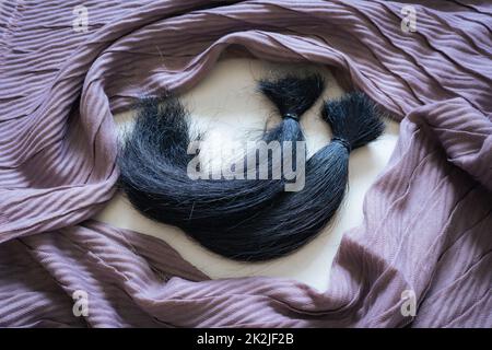 Locks of hair and head scarf Stock Photo