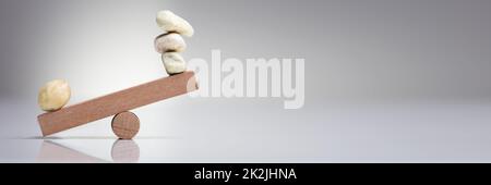 Pebble Stones Balancing On Seesaw Stock Photo