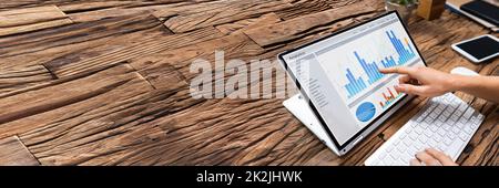 Businesswoman Analyzing Graph On Laptop Stock Photo