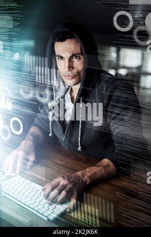 Working hard to beat his deadline. Shot of a young programmer working on his computer late at night. Stock Photo