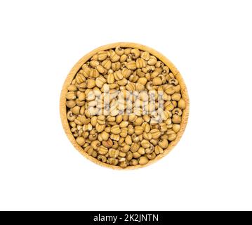 Uncooked dry Job's tears in wooden bowl on white background, top view. Stock Photo