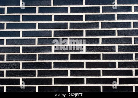 Black brick exterior wall, texture with white grout Stock Photo