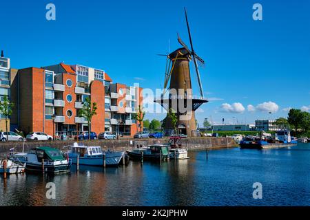 View of the harbour of Delfshaven and the old grain mill De Destilleerketel. Rotterdam, Netherlands Stock Photo